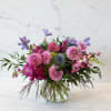 Pink and purple mixed bouquet in a clear glass vase