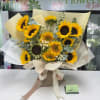 Bouquet of sunflowers wrapped in cream paper with a ribbon bow