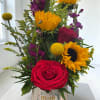 Bright yellow sunflowers paired with deep red roses and pops of purple