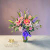 Mixed bouquet in a glass vase with lilies, gerbera daisies, and roses