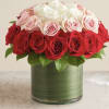 Red and white roses arranged in a glass vase
