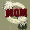 Floral standing tribute shaped like the word LOVE in red and white flowers