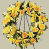 Yellow floral wreath on a black stand