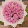 Bouquet of pink roses wrapped in pale paper
