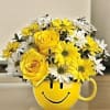 Yellow smiley-face mug filled with yellow and white flowers