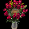 Dense cluster of deep red roses with yellow filler, green foliage in