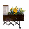 Casket spray with yellow, blue, and white flowers