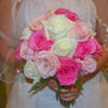 Bride holding a bouquet of pink and white roses