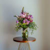 Mix of season flowers with lush florals which may include roses, spray