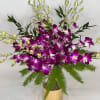 A gorgeous arrangement of premium Dendrobium orchids with luscious greenery in an