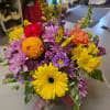 Bright mixed bouquet with gerbera daisies, chrysanthemums, and a butterfly pick