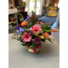 A vibrant, hand-designed mix of cheerful pink Gerberas, elegant irises, and sun-kissed