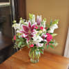Bouquet of pink lilies and roses in a glass vase
