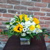 This adorable bouquet is designed in a glass vase with yellow sunflowers