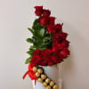 Red roses in a white hatbox with a red ribbon and Ferrero Rocher chocolates