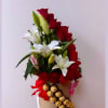 Red and white lily arrangement with gold chocolates on a hat box