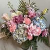 Indulge in the beauty of this meticulously crafted floral arrangement, featuring a