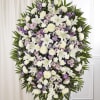 A graceful standing spray designed in soft white and soothing lavender tones