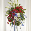 A striking red, white, and blue standing spray designed to honor a