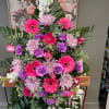Large standing floral spray with pink, purple, and white flowers