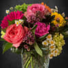 A :Just Because" arrangement made with pink roses and matching filler flowers.