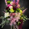Pastel pink roses and cushiony hydrangeas meet vivid purple delphinium spikes in