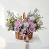 Lavender and pink flower basket with a ribbon bow