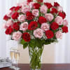 Bouquet of red and pink roses in a clear glass vase