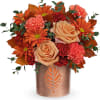 Orange and peach bouquet in a copper vase with leaf cutout