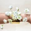 A luxurious wire-frame cuff adorned exclusively with premium blooms, creating a floral