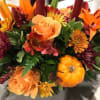 Autumn bouquet with orange roses, lilies, and chrysanthemums