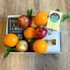 Gift box with oranges, apples, and packaged cheese and crackers