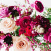 Bouquet of pink, burgundy, and cream flowers with mixed blooms