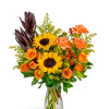 Bouquet of sunflowers, orange roses, and carnations in a clear glass vase