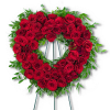 Heart-shaped wreath of red roses with green foliage on a stand