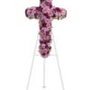 Purple and pink floral cross on a white stand