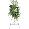 Tall white rose and greenery standing spray on an easel