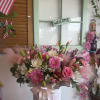 Pink and white mixed bouquet in a round hatbox with ribbon