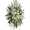 Tall white floral standing spray with lilies and roses on an easel