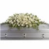 White floral casket spray with roses, calla lilies, and greenery