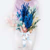 Colorful bouquet with blue and pink dried flowers tied with a ribbon
