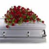 Red rose casket spray on a gray casket