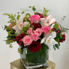 A lush mix of blushing pink and deep red roses framed by