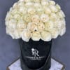 Cream-white roses arranged in a black hatbox