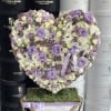 Heart-shaped floral arrangement in lavender, white, and cream tones