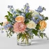 Bouquet of peach and white roses with pink chrysanthemum in a glass vase