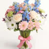the blue delphinium, is dazzling on its own. Surrounded by roses, Peruvian
