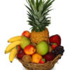 Fruit basket with pineapple, bananas, apples, grapes, and strawberries