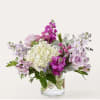 Lavender and white mixed bouquet in a clear glass vase