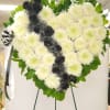Heart-shaped white chrysanthemum wreath with black roses and ribbon